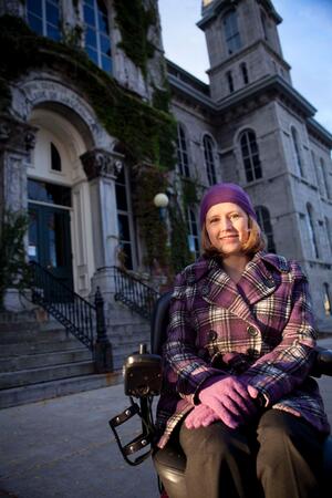 Stephanie Woodward, president of the Disability Law Society and second-year law student, sits in front of the Hall of Languages, one of Syracuse Universitys least handicap accessible buildings.