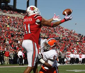 Louisville tight end Josh Chichester (11) catches a touchdown pass over Syracuse safety Olando Fisher (2) on Saturday.