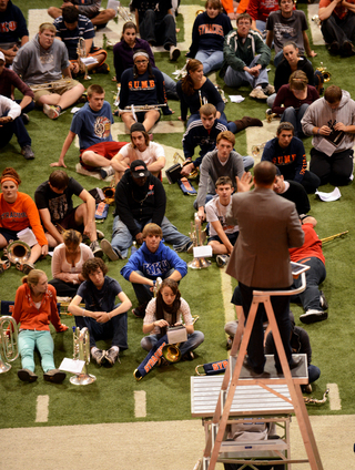 Students gather around professor Mertz to go over key points of a practice.