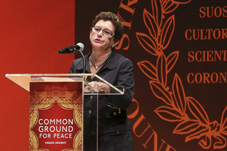 SU Chancellor Nancy Cantor addresses the crowd in Goldstein Auditorium before Monday morning's 