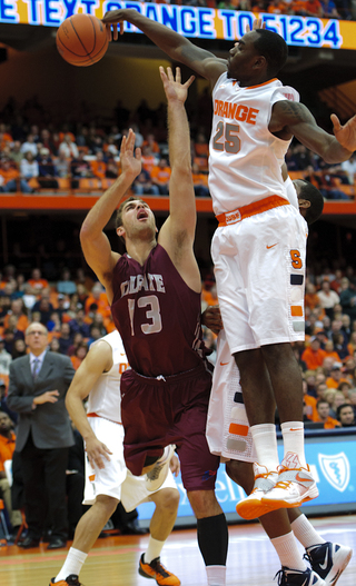 Rakeem Christmas blocks a shot attempt by Colgate's Murphy Burnatowski in Syracuse's 87-51 win on Sunday.