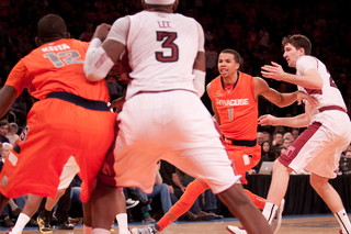 Baye Moussa Keita jostles for positioning with Temple's Anthony Lee while Carter-Williams negotiates traffic.