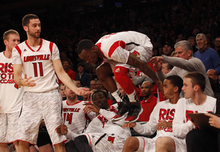 Louisville's Russ Smith flies back onto the court after chasing a ball that was thrown out of bounds.