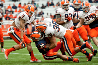 Syracuse linebacker Cameron Lynch levels running back Steve Rene.