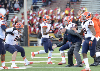 Scott Shafer reaches down to high five Robert Welsh. Welsh finished with four tackles and had one sack late in the fourth quarter. 