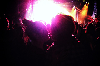 Jillian Clark (L) and Ryn Adkins (R) share a moment and embrace each other during Macklemore's performance of 