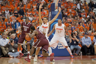 Tyler Ennis and DaJuan Coleman slide to defend a driving Rams guard.