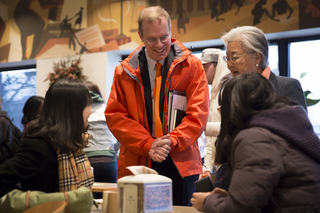 Chancellor Kent Syverud and his wife, Dr. Ruth Chen speak with students in Schine. 