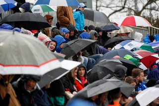 Fans in Koskinen Stadium use umbrellas to stay dry as a light rain falls throughout the game. 3,215 fans were on hand for the game. 