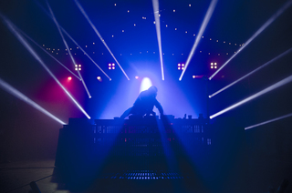 Skrillex jumps onto his DJ booth as the crowd eagerly waited for him to start his set. 