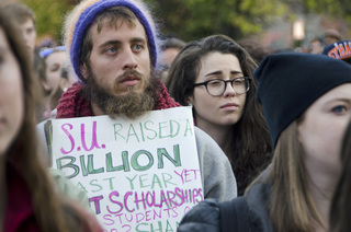 Zach Ulrich, a physics and neuroscience graduate at Tulane University in New Orleans joins a friend from SU in the Diversity and Transparency Rally.