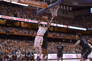 Forward Chris McCullough goes up for a layup with a Holy Cross defender on his back.