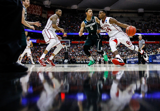 Oklahoma's Buddy Hield (24) drives the ball in the paint around Michigan State's Bryn Forbes (5) early in the first half.