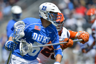 Duke's Will Haus scans the field with an SU pole defending him.