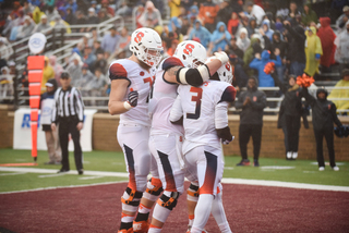 Teammates congratulate Philips on a first-half touchdown.