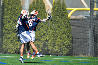 Two Syracuse players celebrate together. 