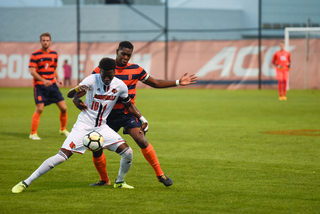 Kamal Miller was called for a yellow card trying to stop Louisville's Mohamed Thiaw. 