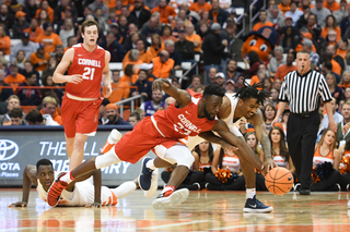 Cornell's Joel Davis and Syracuse guard Geno Thorpe scramble for a loose ball.