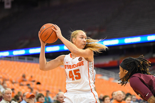 Strautmane holds the ball away from a defender.