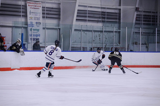 Passing the puck around the ice, Hicks (No.2) and Bellefontaine (No.8) wore down the defense.