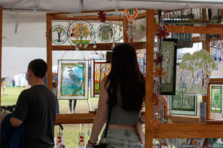 Customers walk through a stained glass tent at the festival. The vendor of this stand had stained glass in a number of different shapes, sizes, patterns and designs that caught people’s eyes as they walked past. 