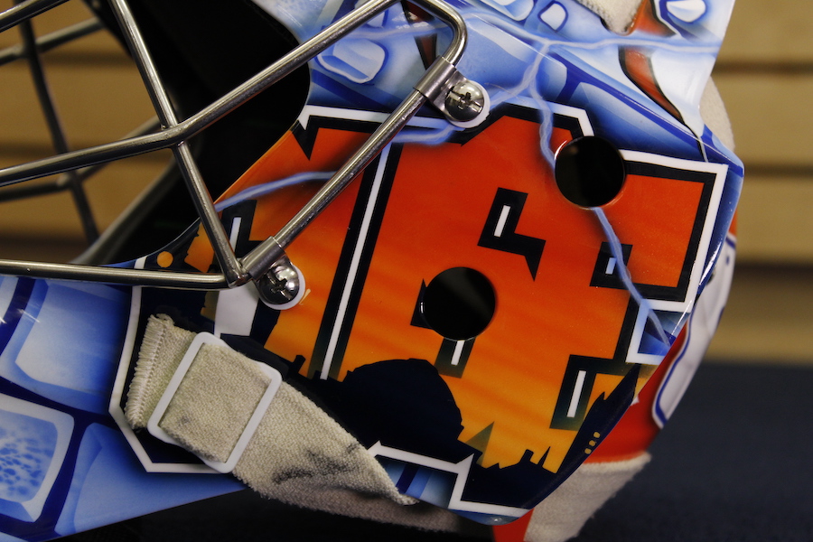 The left side of Allison Small’s mask with the Syracuse skyline within the word CUSE.